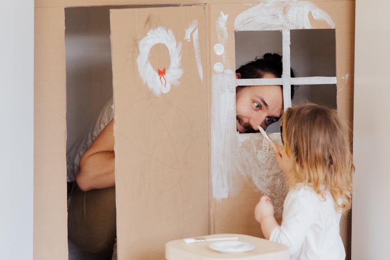 Father and daughter painting together